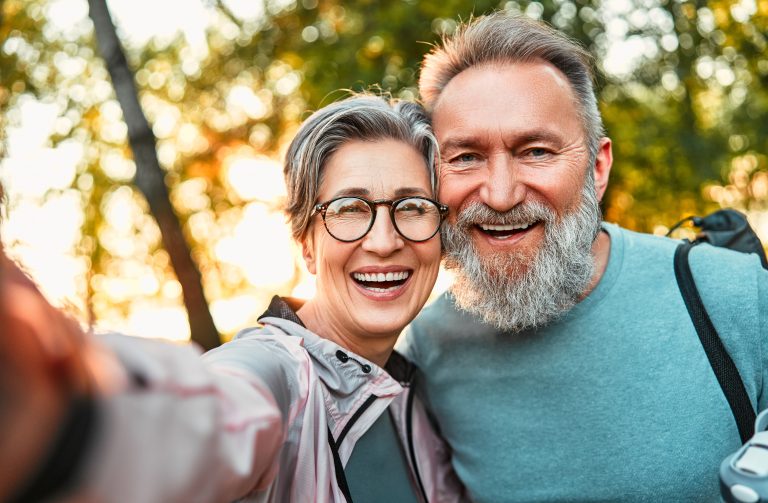 older smiling man and woman hiking