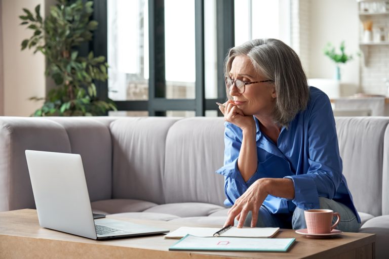 older woman working at laptop