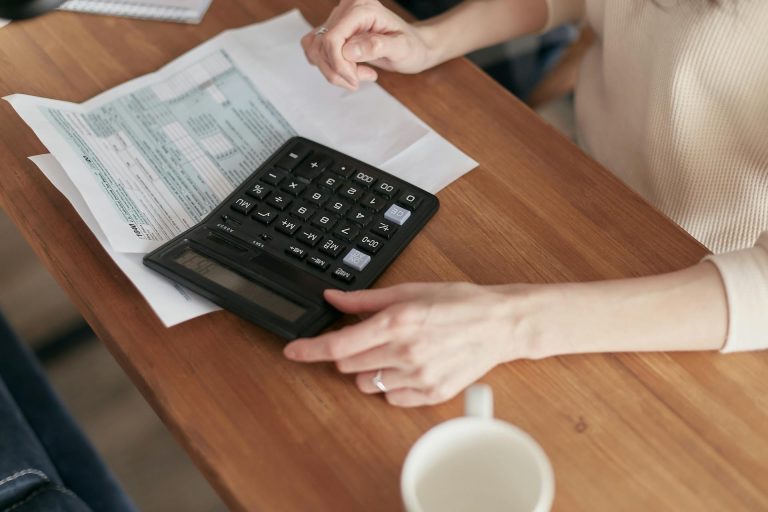 woman using a calculator to estimate income